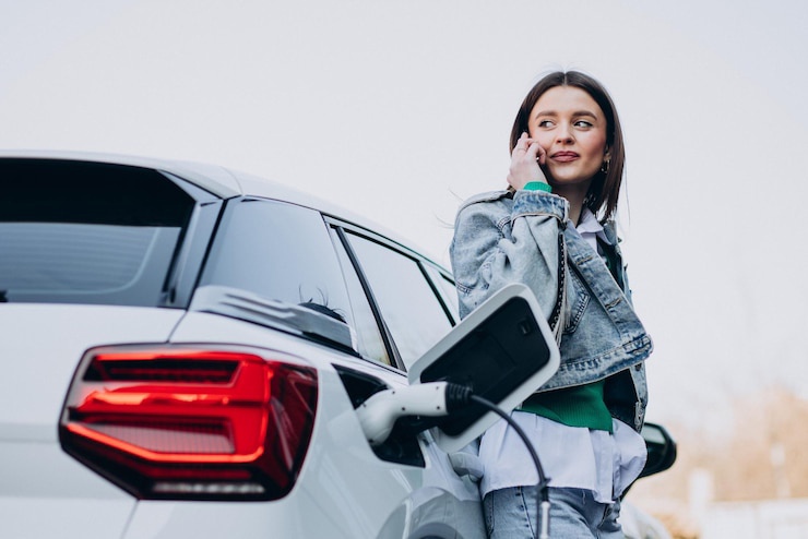 woman-charging-her-electric-car-with-charging-pist